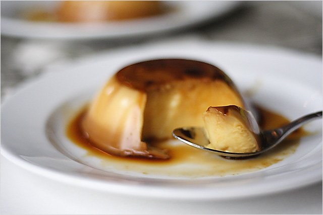 Crème caramel flan with caramel sauce on a plate.