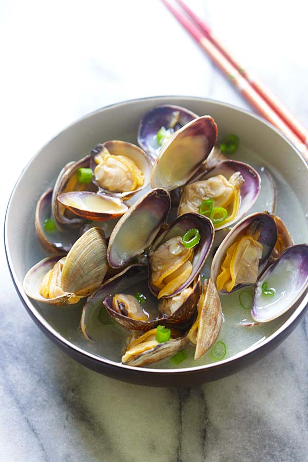 Fresh Japanese Manila (Asari) clams steamed with butter, Japanese sake and mirin in a bowl.