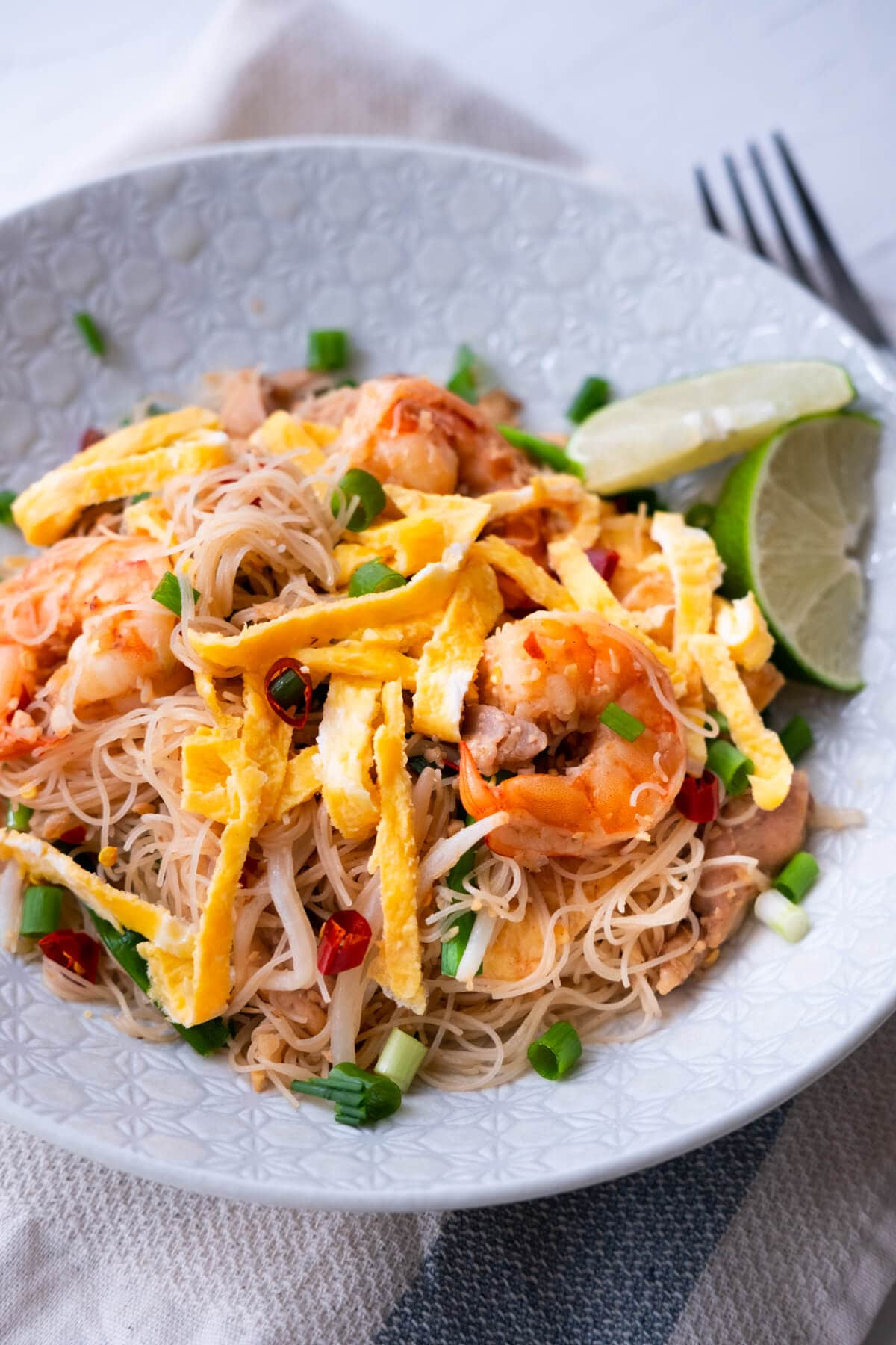 Spicy stir fried rice noodles topped with chilies and Chinese chives. 