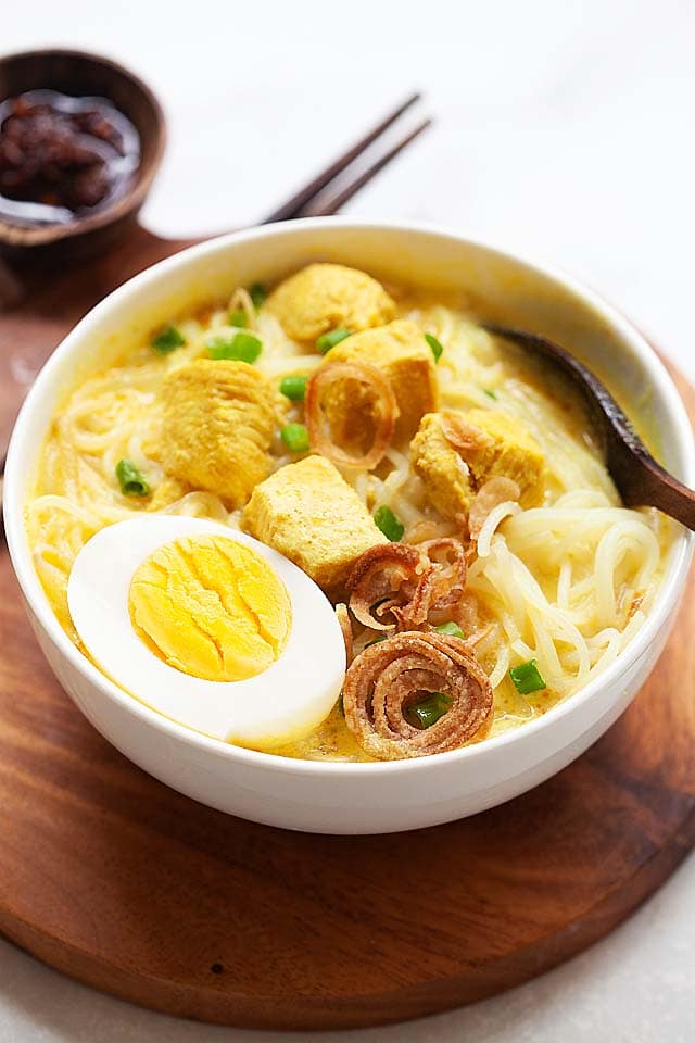 Soto ayam recipe with chicken and spices in a soup.