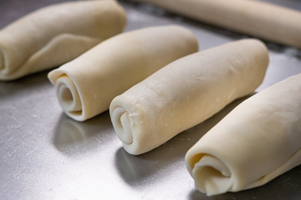 Rolling curry puff pastry into rolls. 