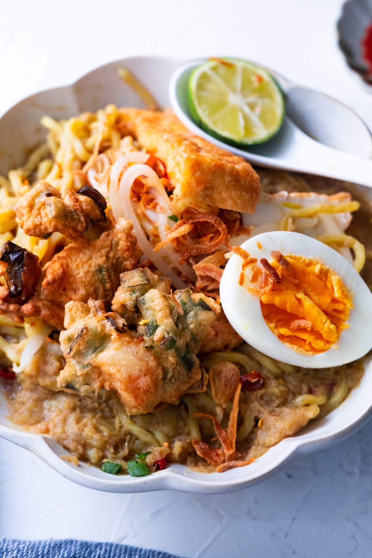 Mee rebus served with lime and chili sauce. 