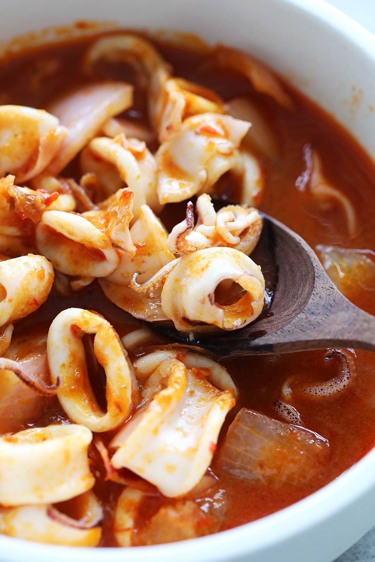 Squid sambal in a bowl with red sambal sauce. 