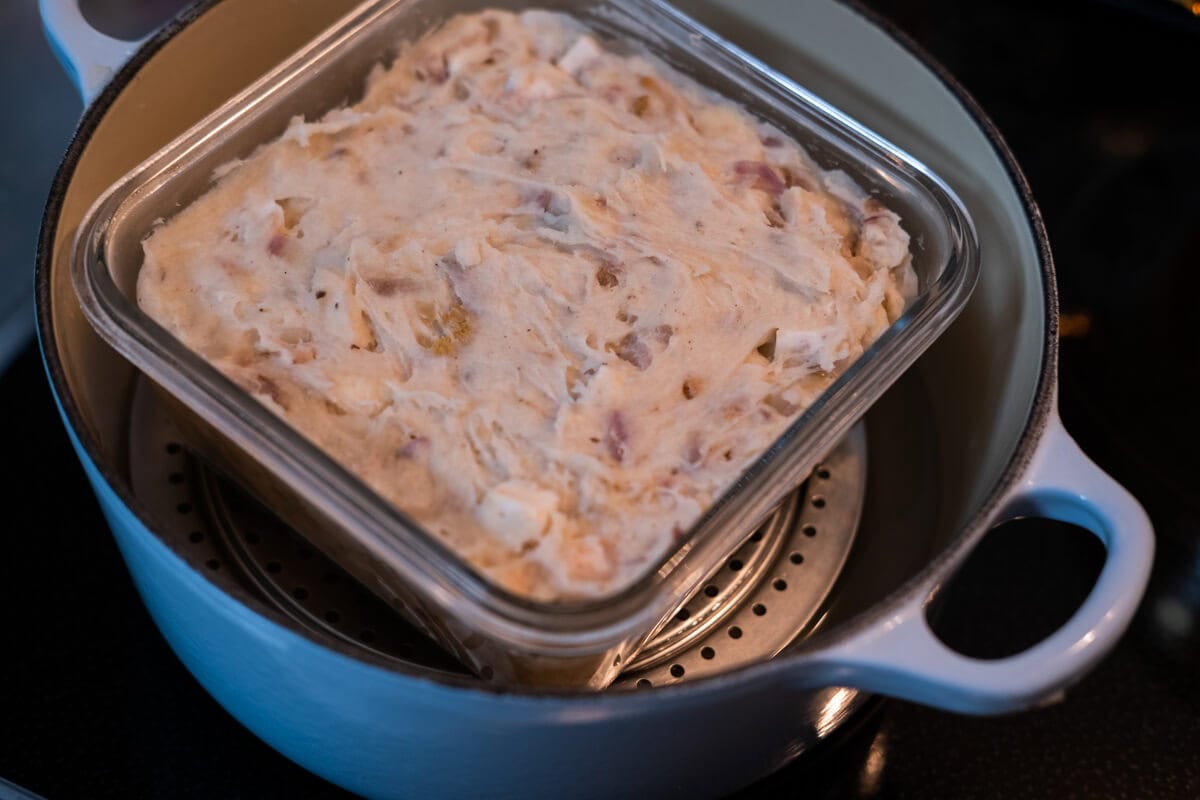 Transfer the yam cake mixture to a glass container and steam it. 