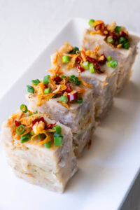 Sliced yam cakes served on a plate.