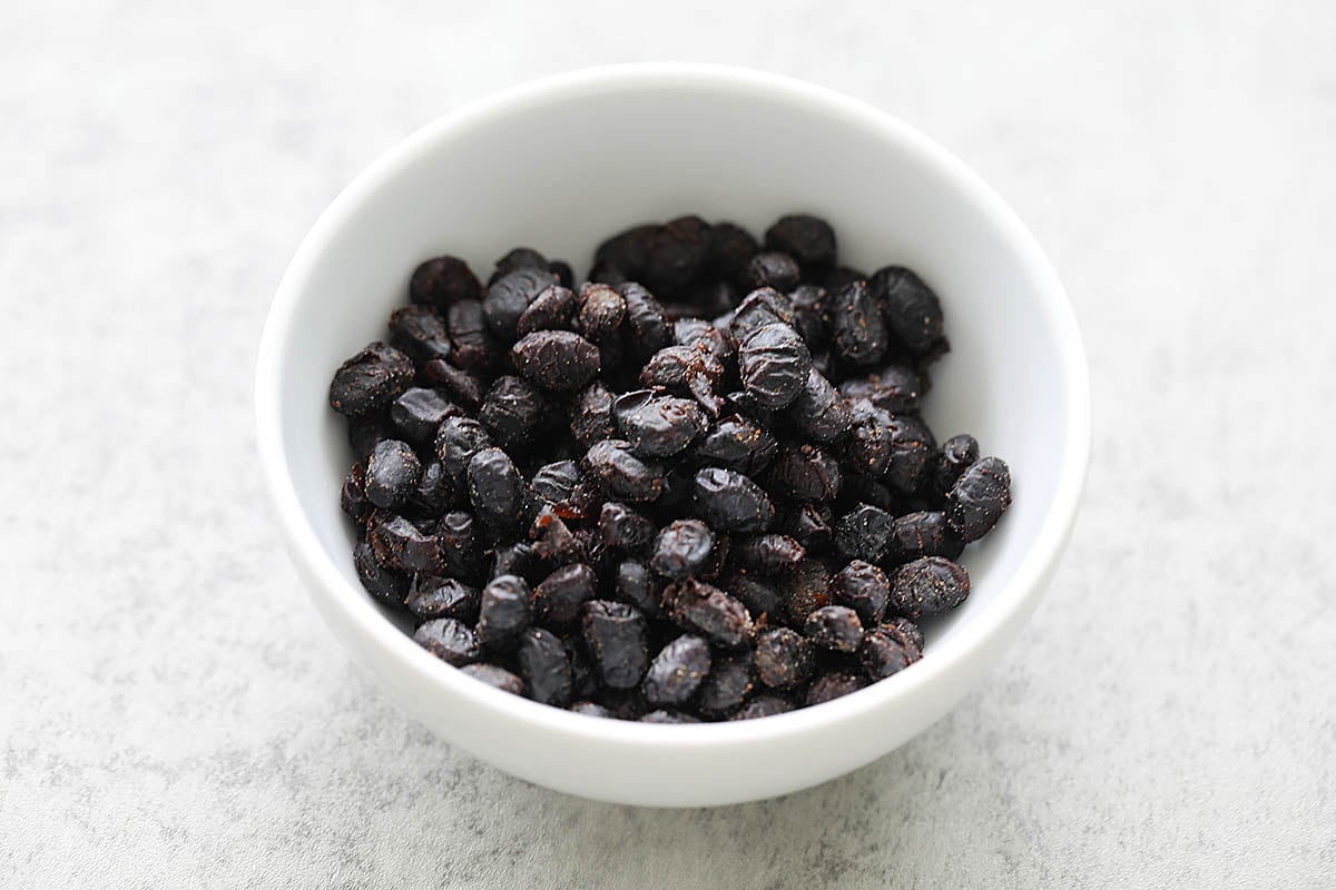 Fermented black beans in a small bowl. 