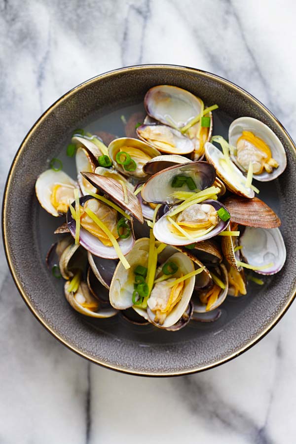 Chinese style ginger and clam clear soup, in a bowl.