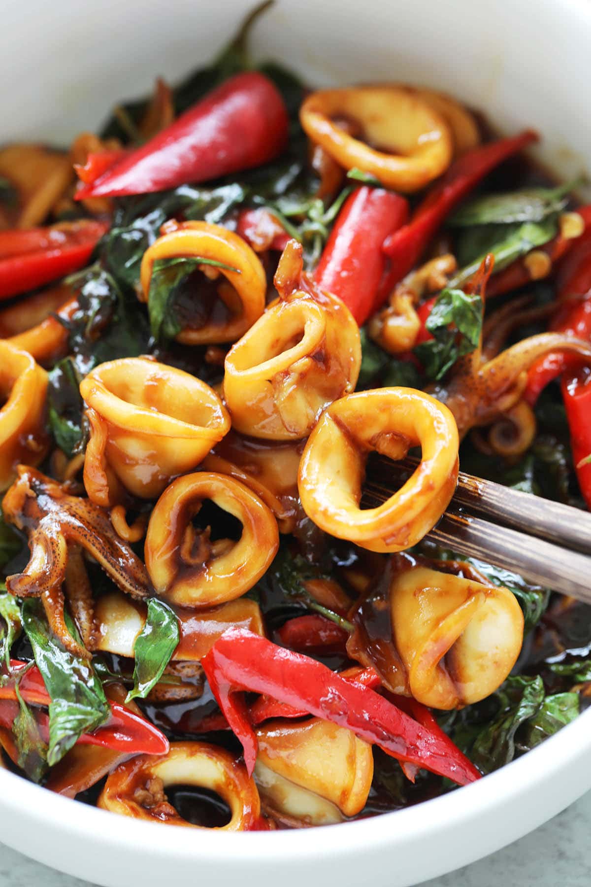 Tender squid rings coated with dark stir-fry Asian sauce. 