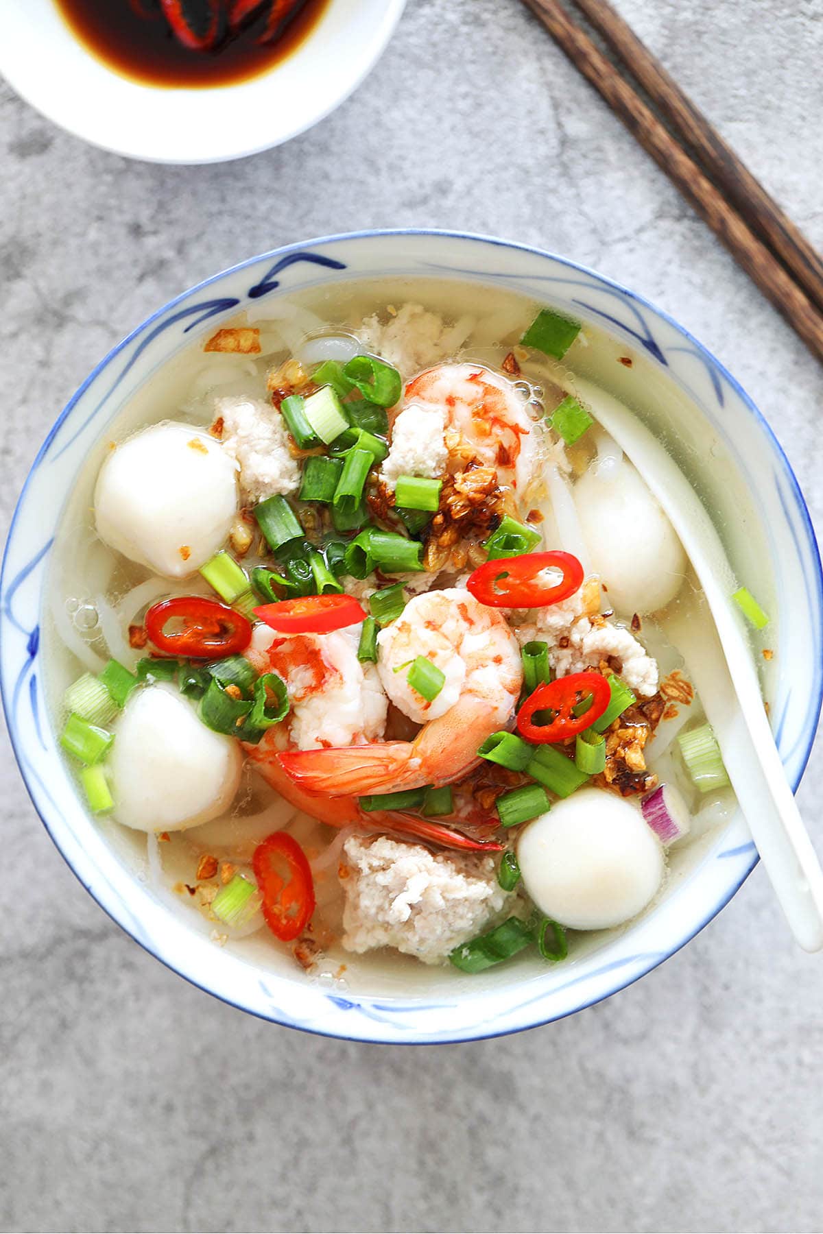 Rice noodle soup recipe made with bee tai bak rice noodles, fish balls, pork and shrimp in a clear soup.