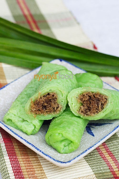 Kuih dadar or kuih tayap is a rolled crepe flavored with pandan juice and filled with grated coconut steeped in gula melaka or Malaysian palm sugar. | www.666630.xyz