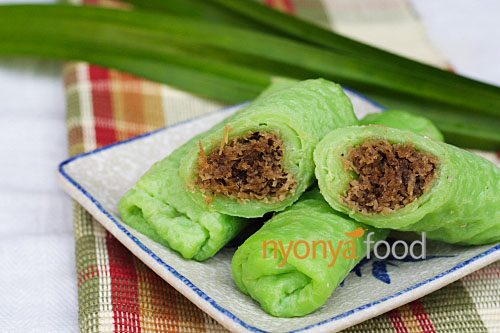 Kuih dadar or kuih tayap is a rolled crepe flavored with pandan juice and filled with grated coconut steeped in gula melaka or Malaysian palm sugar. | www.666630.xyz