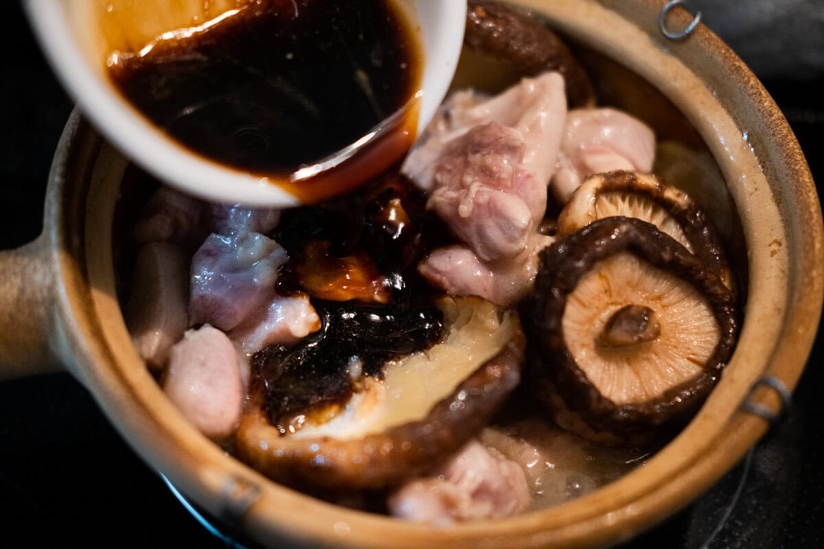 Adding sauce to chicken mushroom stew. 