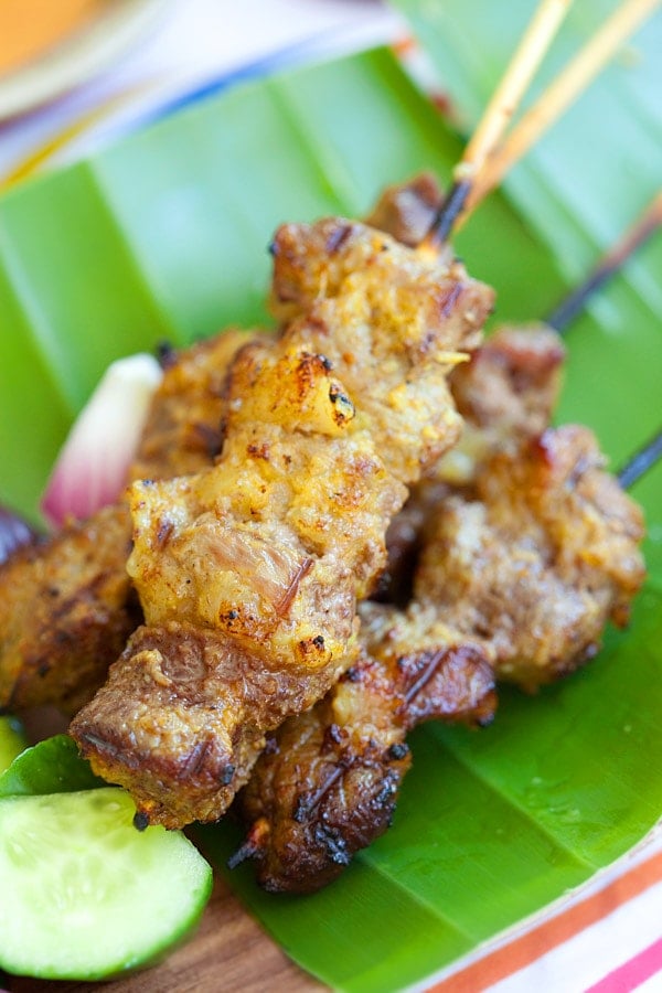 Grilled beef skewers served on banana leaves.