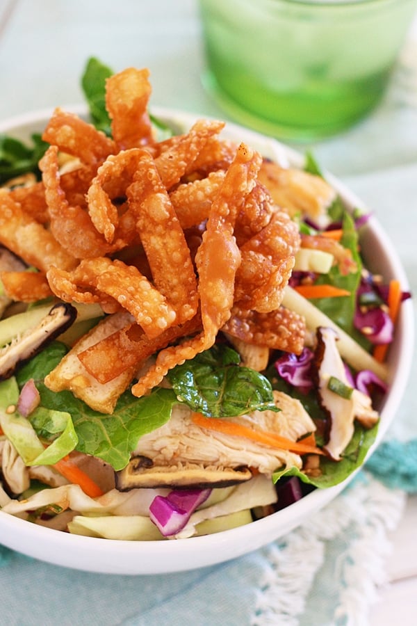 Homemade Chinese Chicken Salad in bowl, with mushrooms and topped with wonton chips.