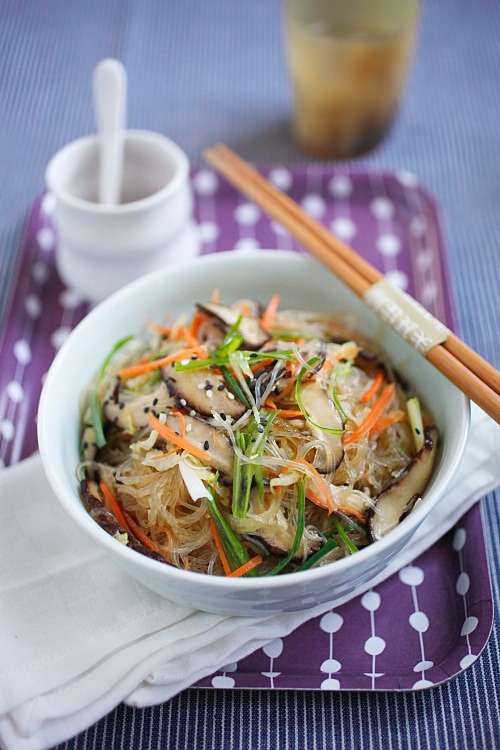 Chinese style vegetable fried noodles served in a bowl with a pair of chopsticks.