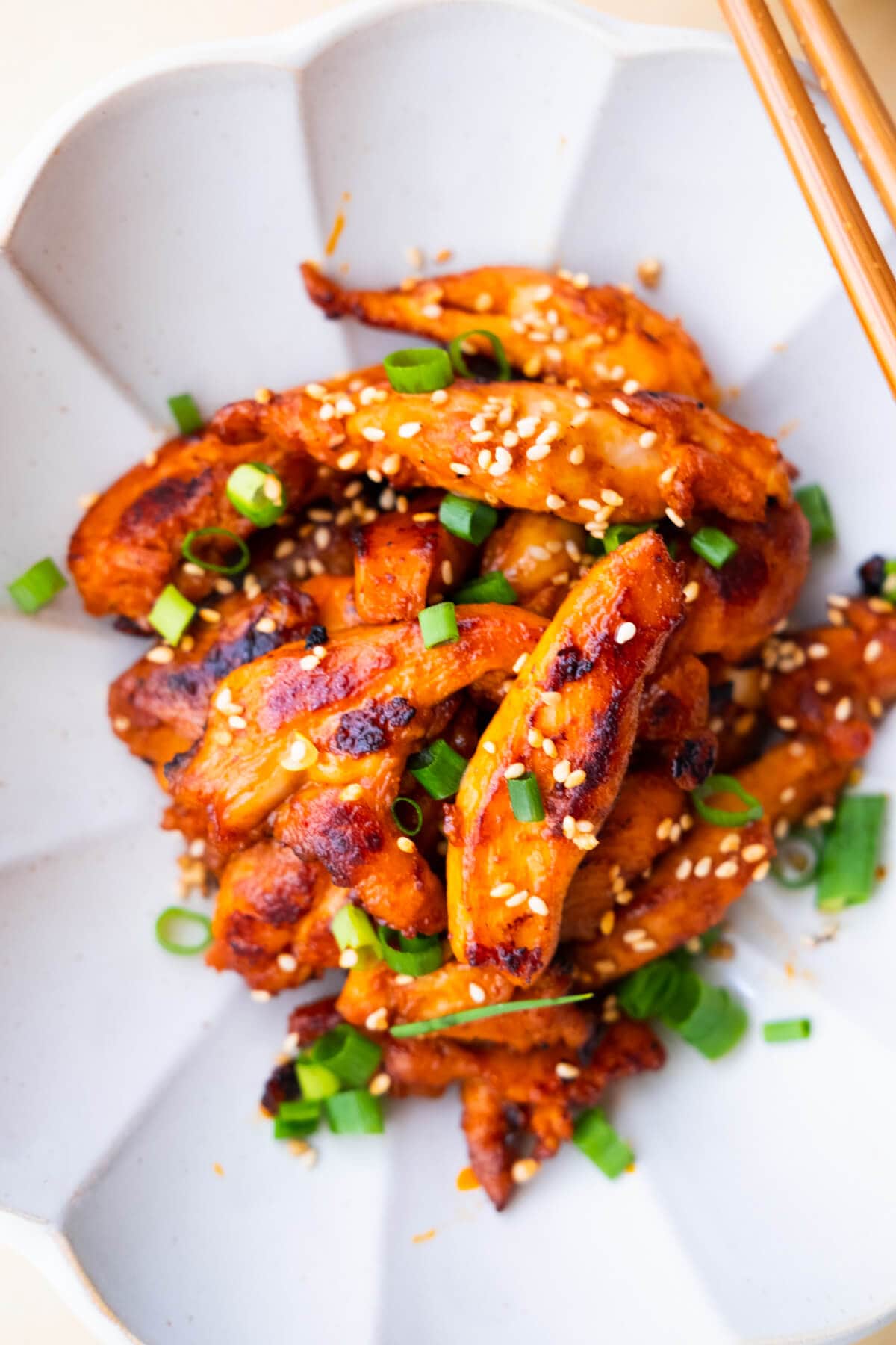 Grilled boneless spicy Korean chicken served on a plate. 