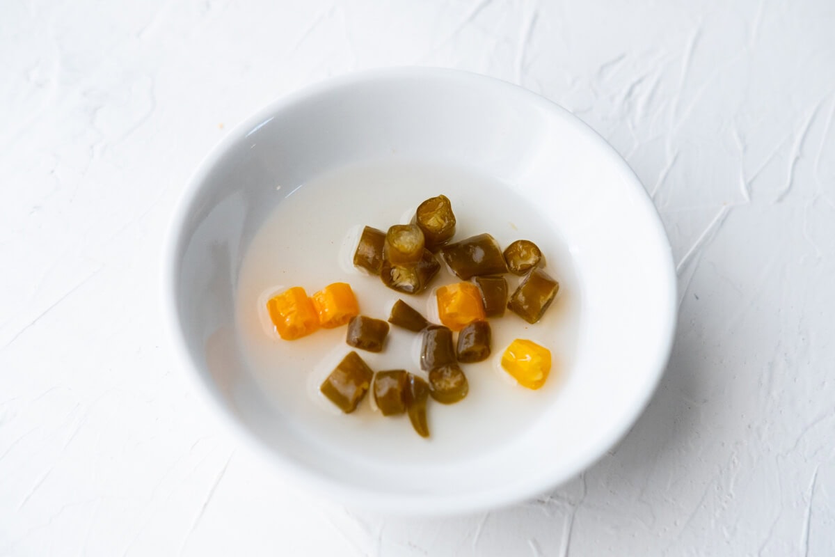 Pickled chilies in a small dish. 