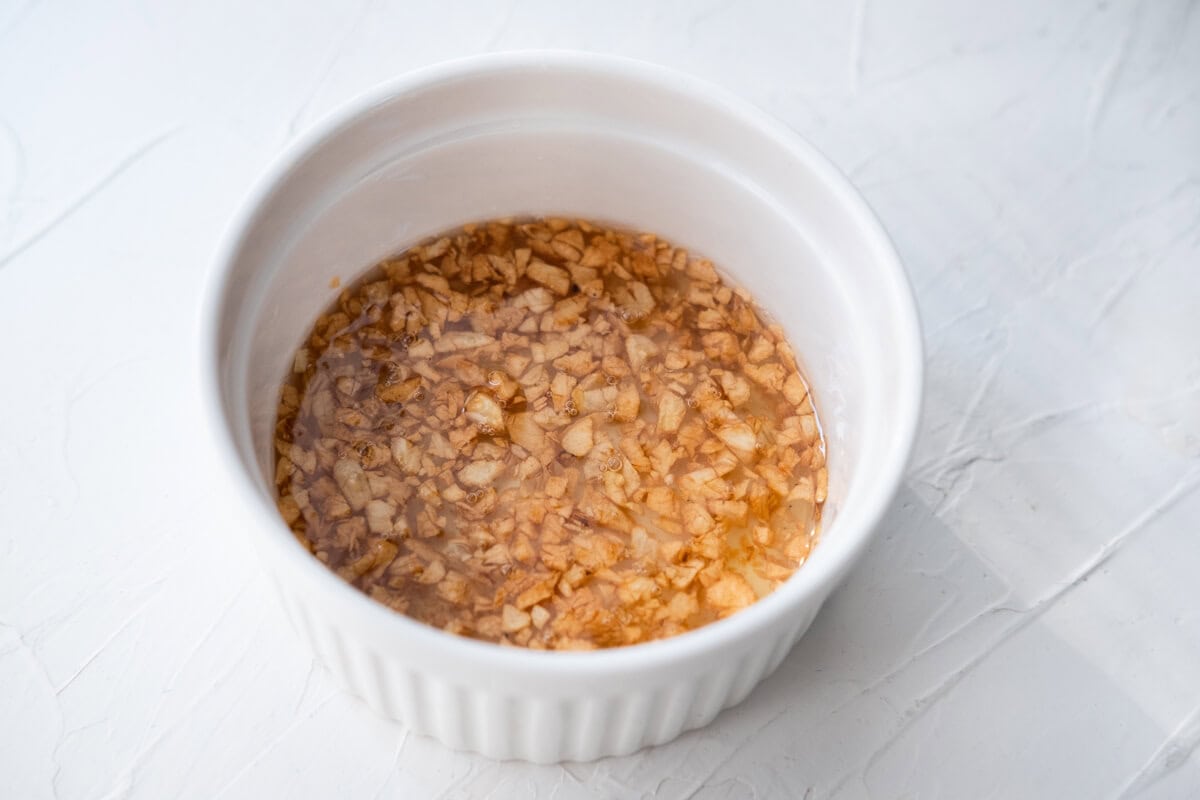 Cooked garlic oil in a small bowl. 