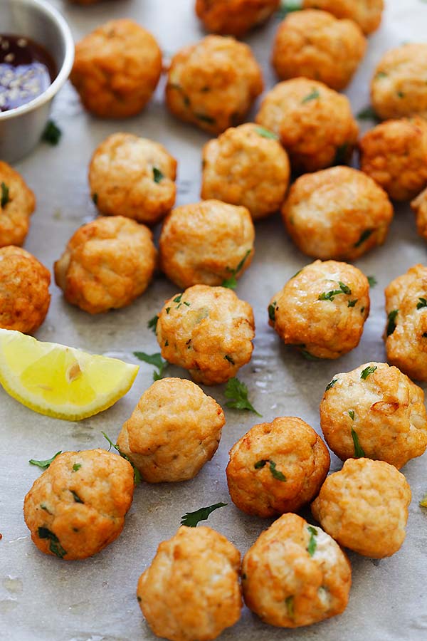 Chicken meatballs served with dipping sauce and a lemon wedge. 