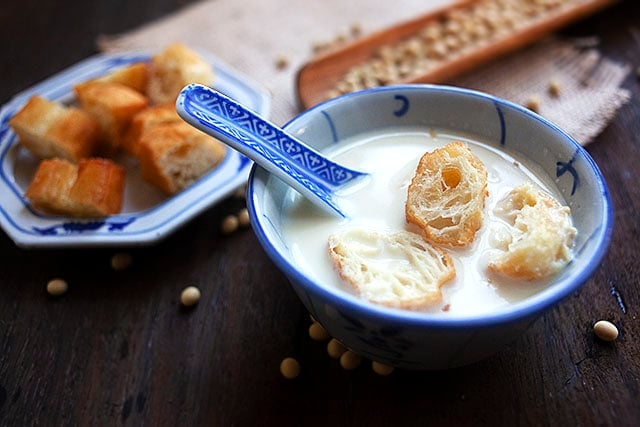 Salty soy milk served with Chinese youtiao in a bowl.