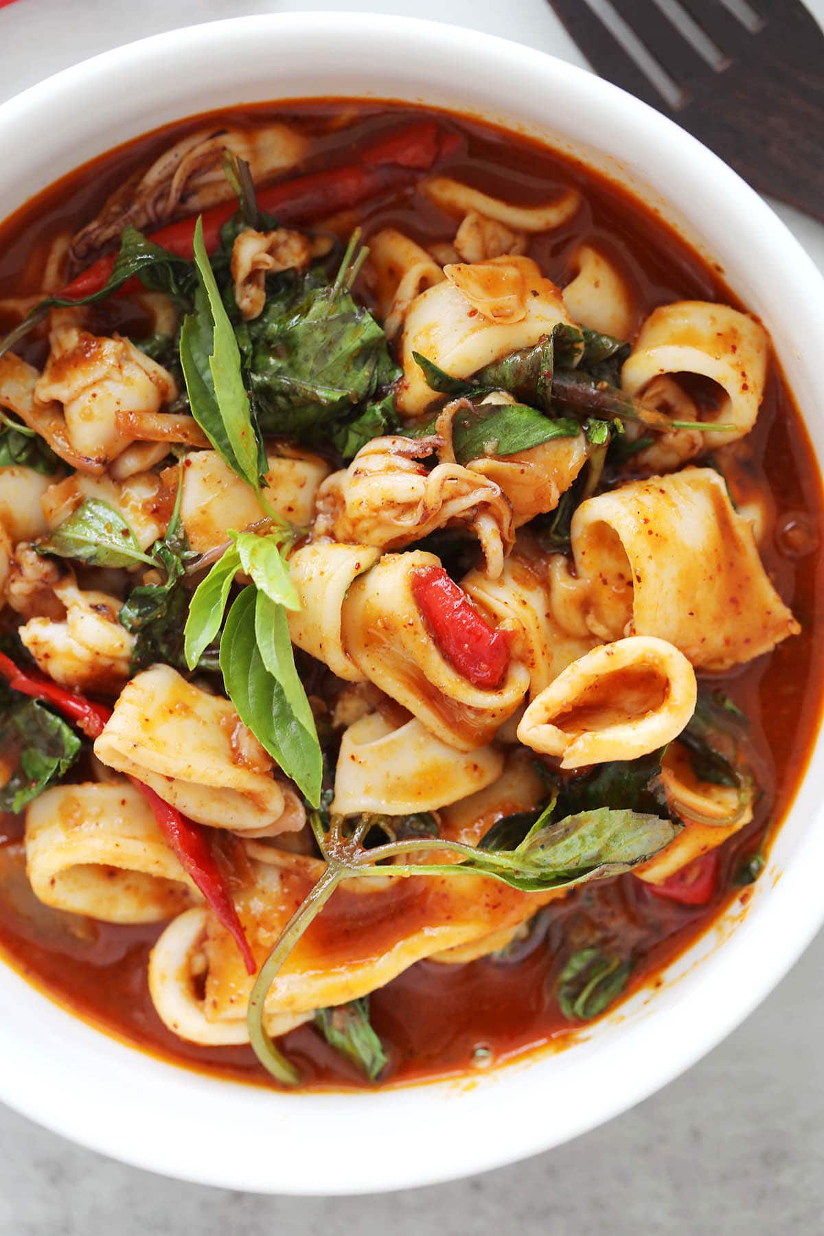 Thai chili squid recipe with tender squid rings in a spicy roasted chili paste sauce. 