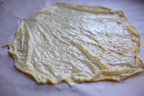  Tofu skin resting on parchment paper to dry.