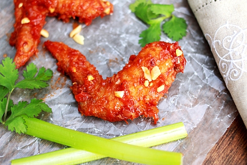 Delicious homemade Thai fried chicken wings with red spicy sauce.