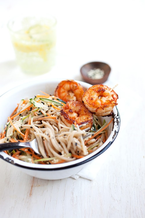 Chilled spicy sesame soba noodles with shrimp with a fork ready to serve.