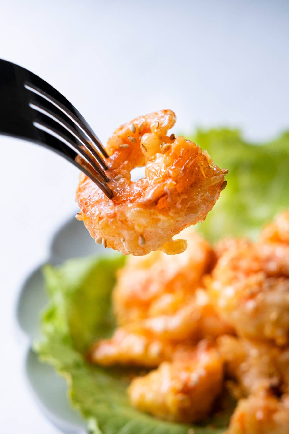 Dynamite shrimp appetizer pierced by a fork. 