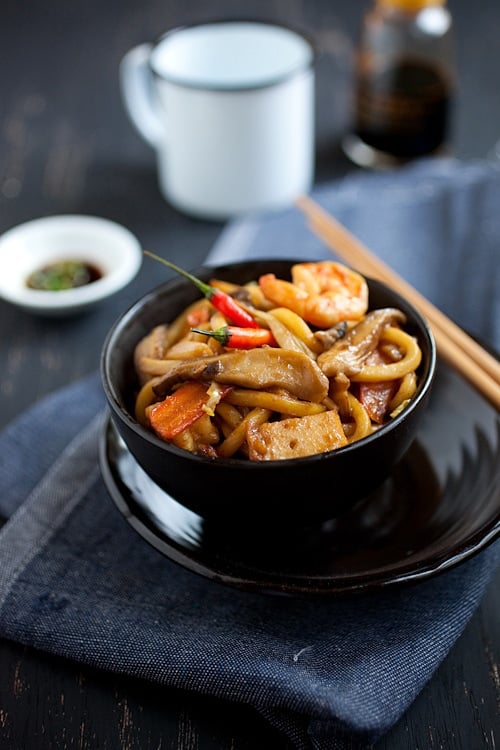 Easy homemade stir fry Malaysian style udon in brown Asian sauce served in a bowl.