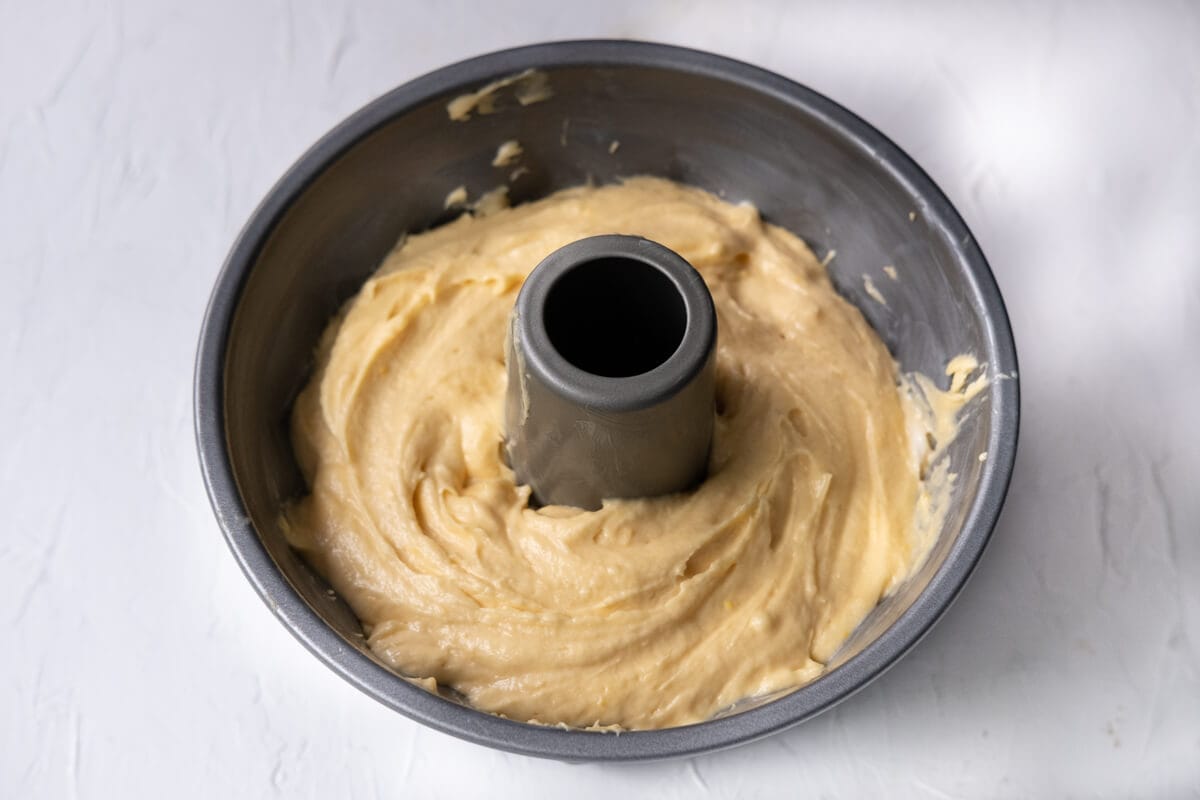 Orange sicilian cake batter in a bundt pan. 