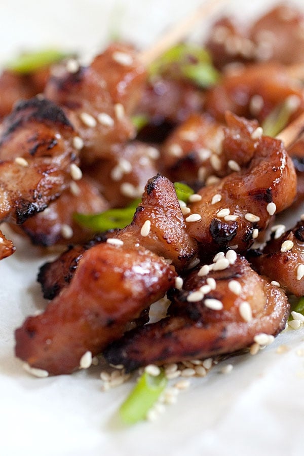 Sticky and sweet honey sesame chicken skewers sprinkled with sesame seeds.