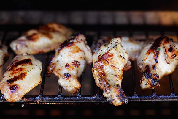 Lemongrass and fish sauce marinated lemongrass chicken wings on an outdoor grill. 