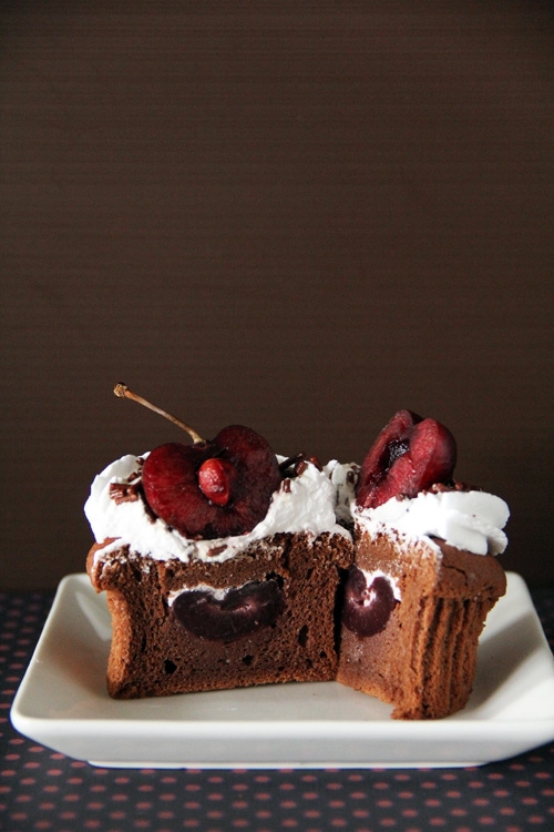 black forest cupcakes made with chocolate, cherries, and whipped cream, in half, ready to serve.