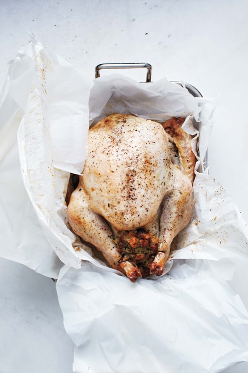 Easy homemade Thanksgiving roasted whole turkey recipe using parchment paper.