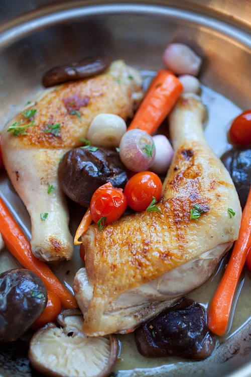 Braised chicken in skillet.