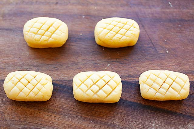 Pineapple tarts with criss-cross patterns on top.