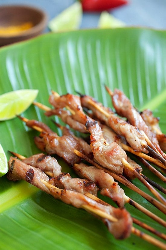 Easy Thai pork skewers with sweet coconut milk glaze on banana leave.