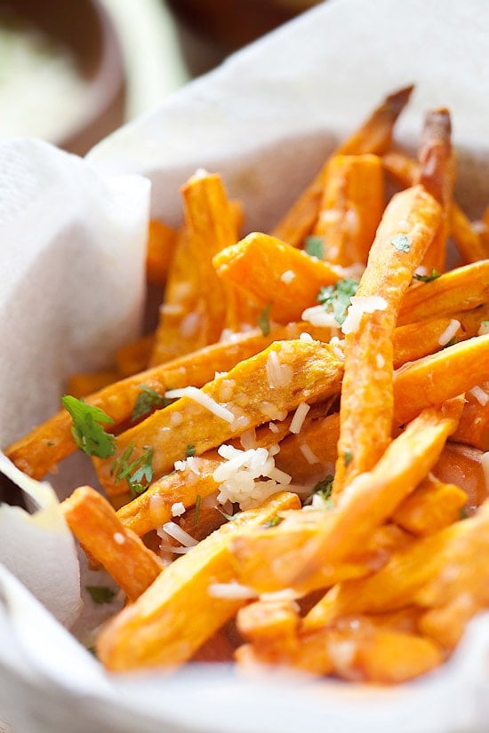 Easy and quick crispy and cheesy sweet potatoes and topped with Parmesan cheese in a basket.