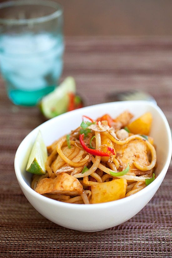 Easy veggie fried noodles recipe with ketchup, soy sauce, and lime in a bowl.