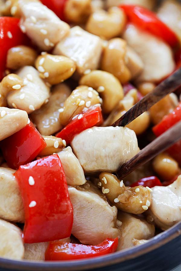 Homemade Chinese Stir-fry Chicken cashew nuts with brown cashew sauce in a bowl with chopsticks ready to serve.