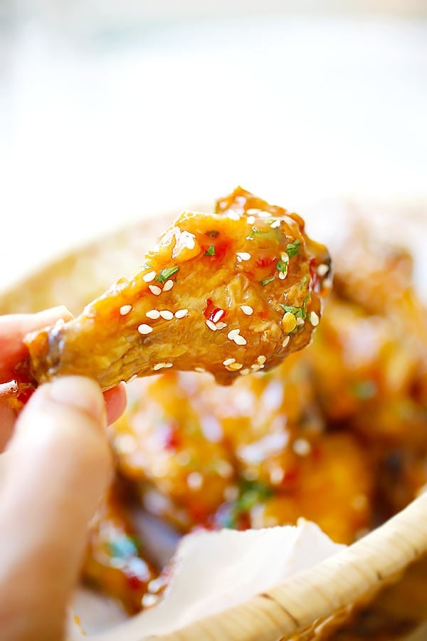 baked orange chicken wings with homemade Chinese sweet sauce in a basket.