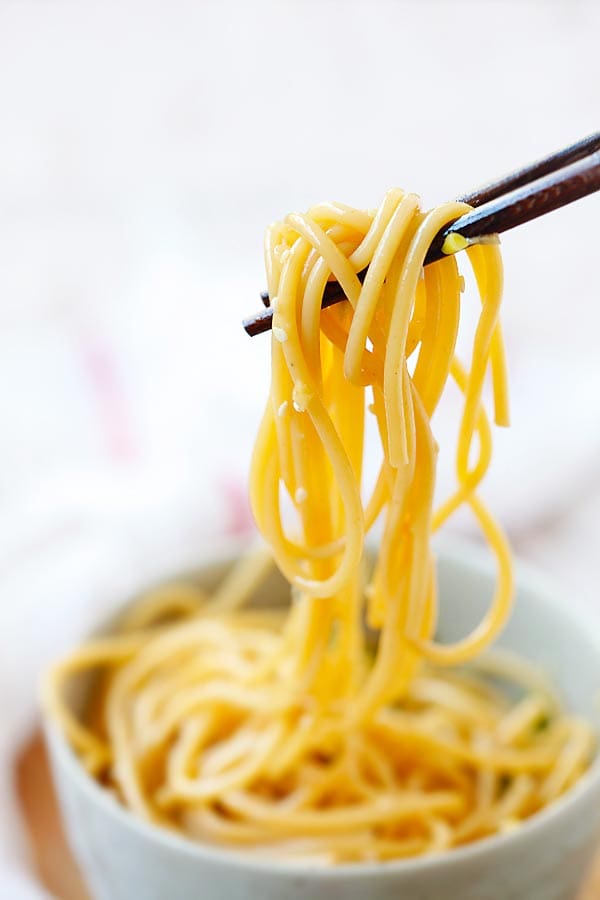 Garlic Sesame spaghetti picked with a pair of chopsticks.