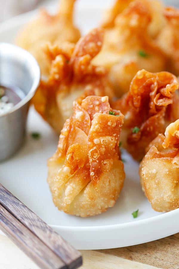 Golden brown chicken wontons served on a plate. 