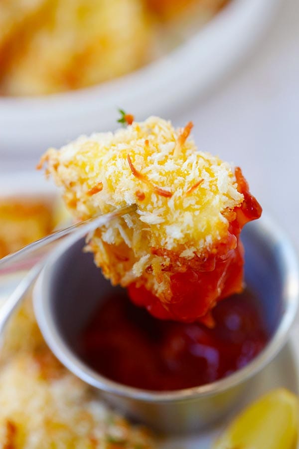 Parmesan Baked Fish Nuggets dipped in homemade sauce.