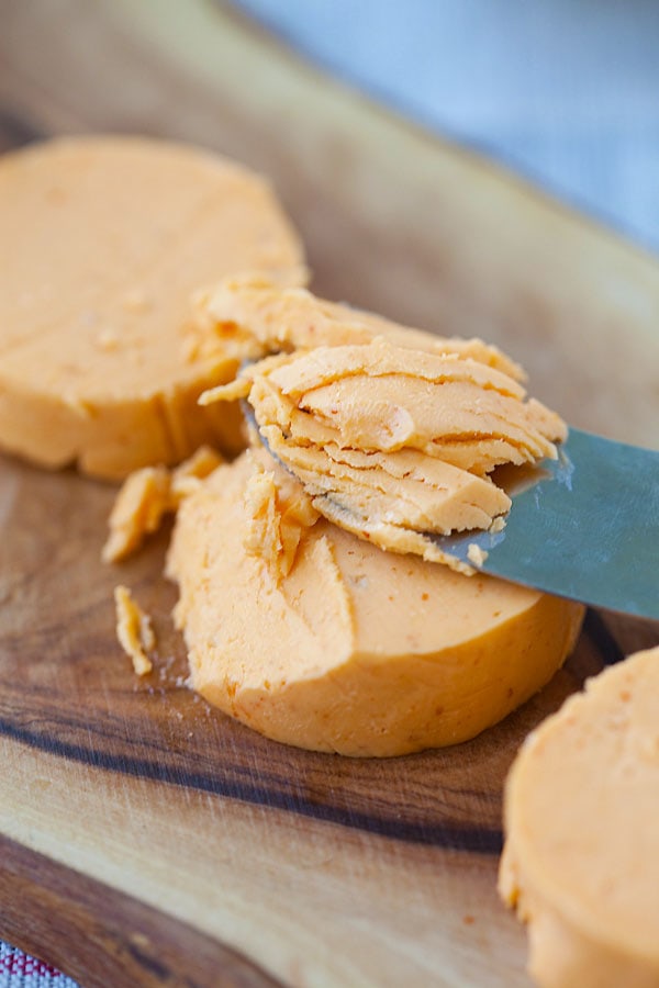 Butter knife scrapping delicious butter made with honey and Sriracha.