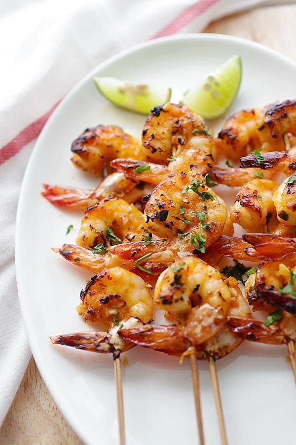 Char-grilled Chili Lime Shrimp skewers on a plate.