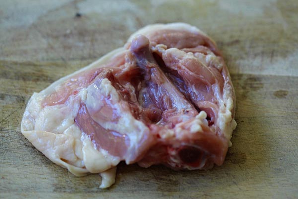 Learn the easy step-by-step to debone chicken thighs so you keep the skin on, but with no bones | www.666630.xyz