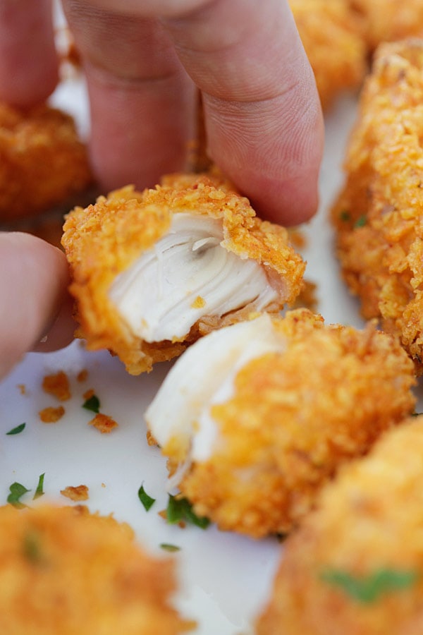 Easy homemade baked crispy tortilla chicken bites in half.