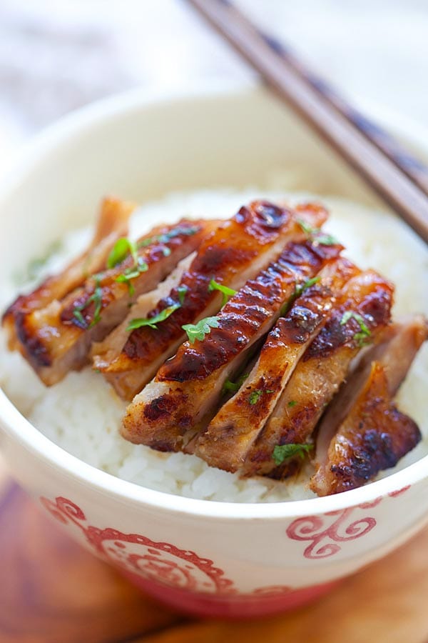 Skillet Lemongrass Chicken sliced and placed on top of steamed rice in a bowl, ready to serve.